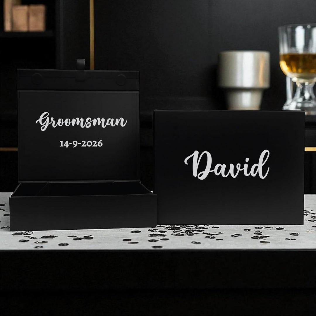 Black gift box with 'Groomsman' and '14-9-2026' text, and another box with 'David' text, on a dark background with wedding gift box