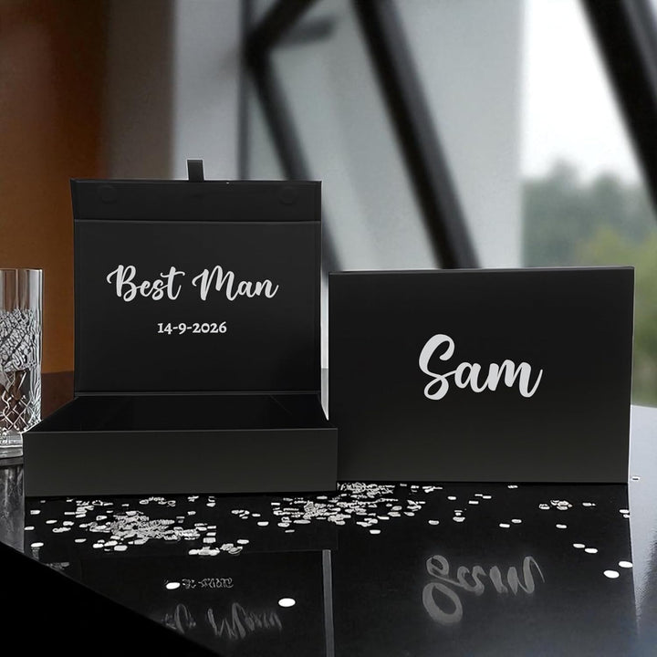 Black place cards with 'Best Man' and 'Sam' text on a reflective Personalised Wedding gift box surface.