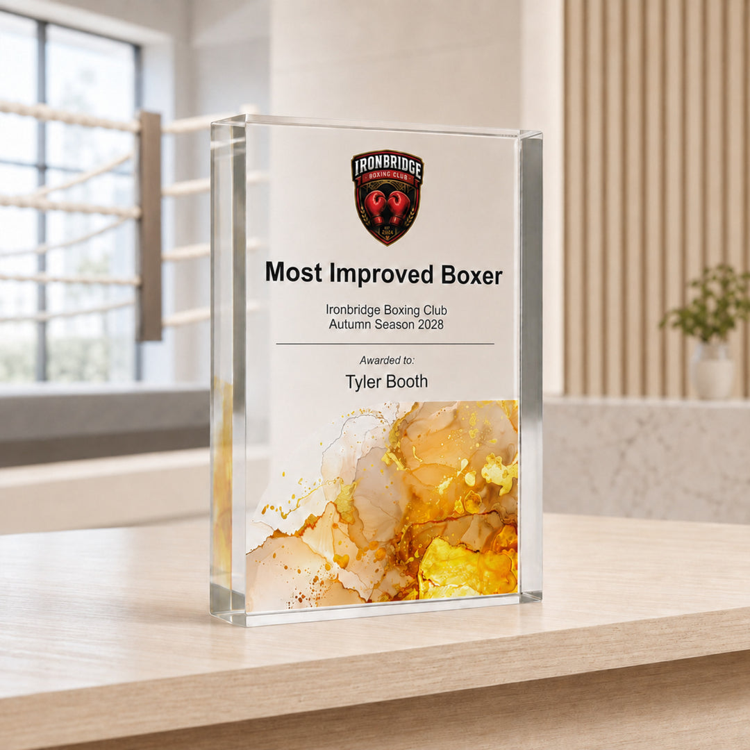 Personalised boxing trophy printed Most Improved Boxer with a club crest and amber base