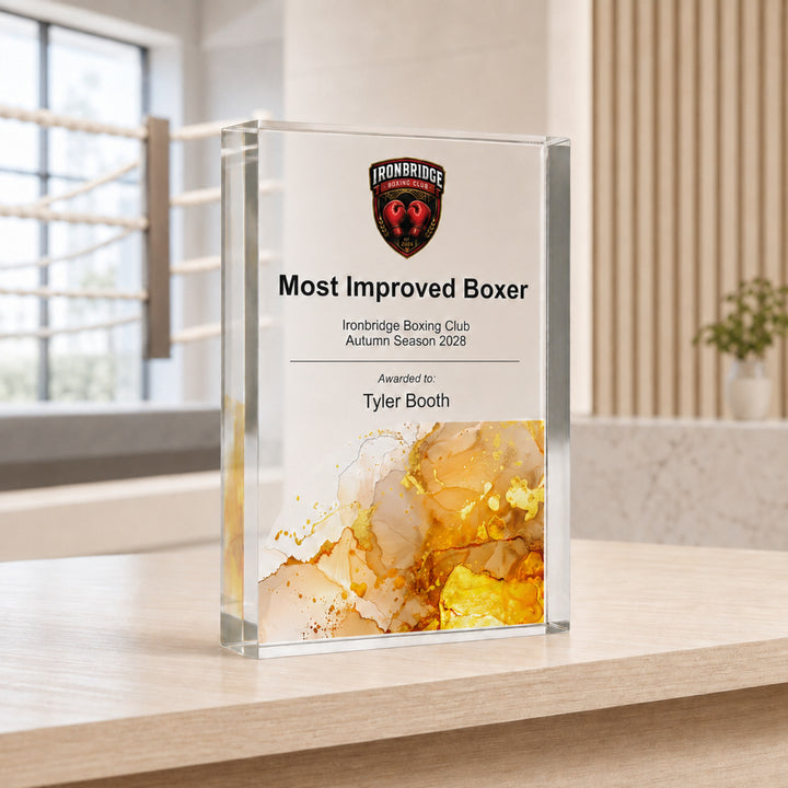 Personalised boxing trophy printed Most Improved Boxer with a club crest and amber base