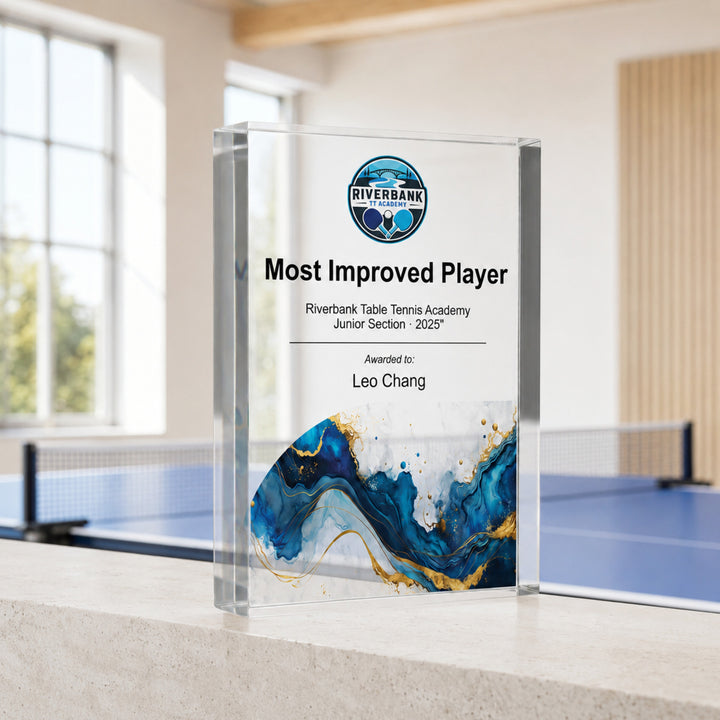 Personalised table tennis trophy printed Most Improved Player with an academy crest and blue base