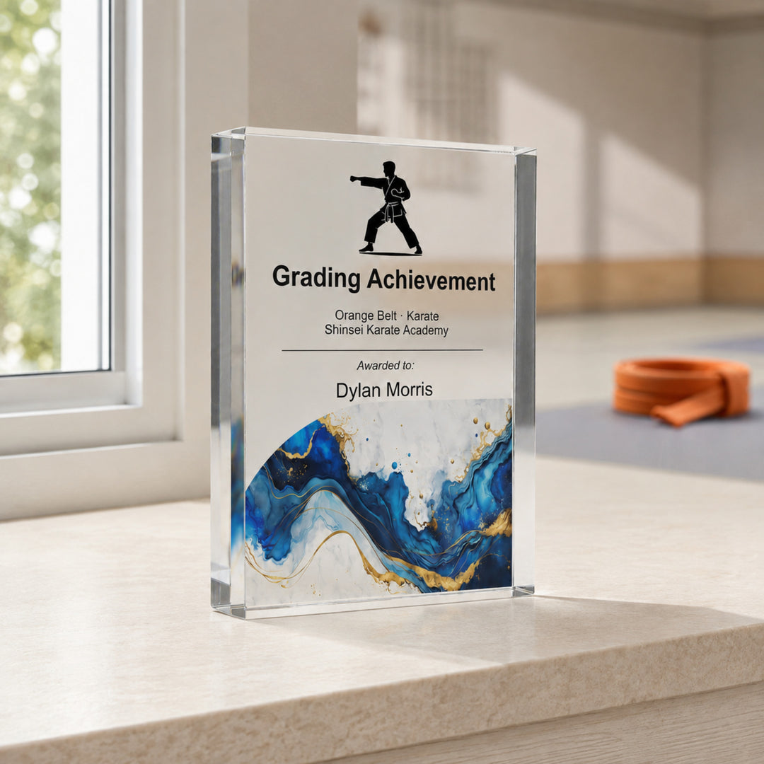 Personalised karate trophy printed Grading Achievement with a karate icon and blue gold base