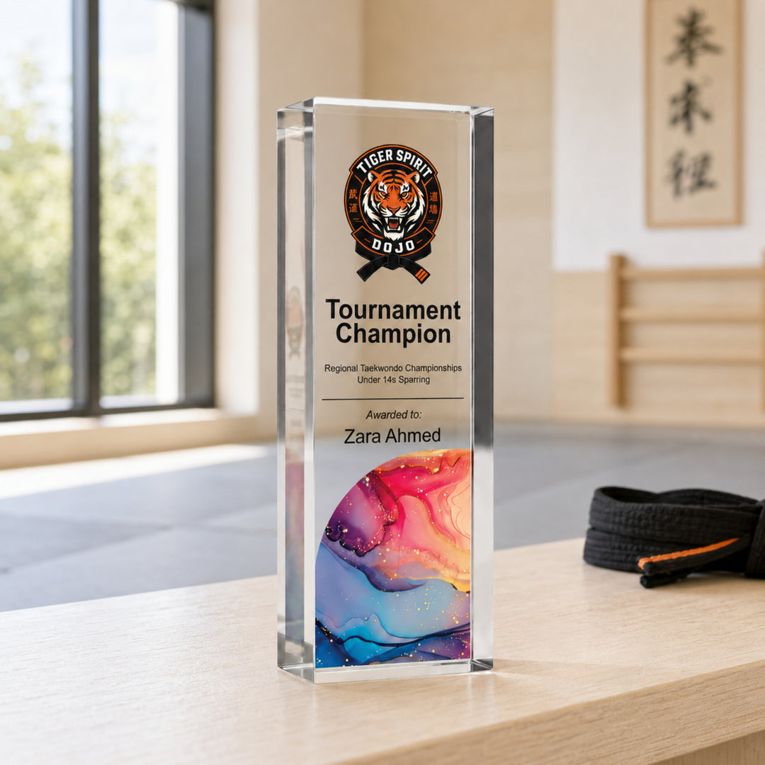 Slim upright personalised martial arts trophy printed Tournament Champion with an academy crest