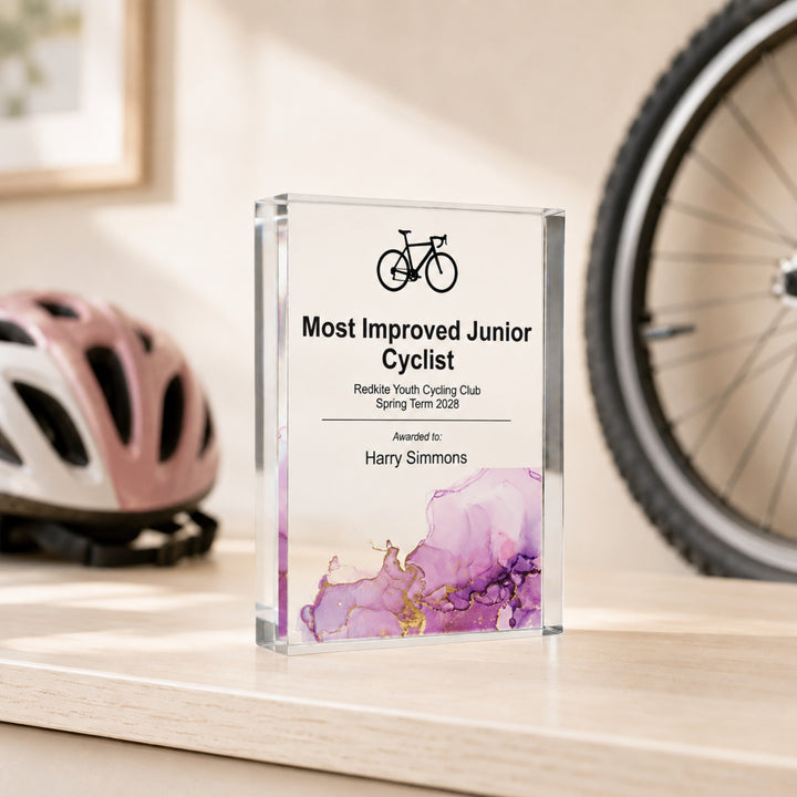 Personalised junior cycling trophy printed Most Improved Junior Cyclist, beside a helmet