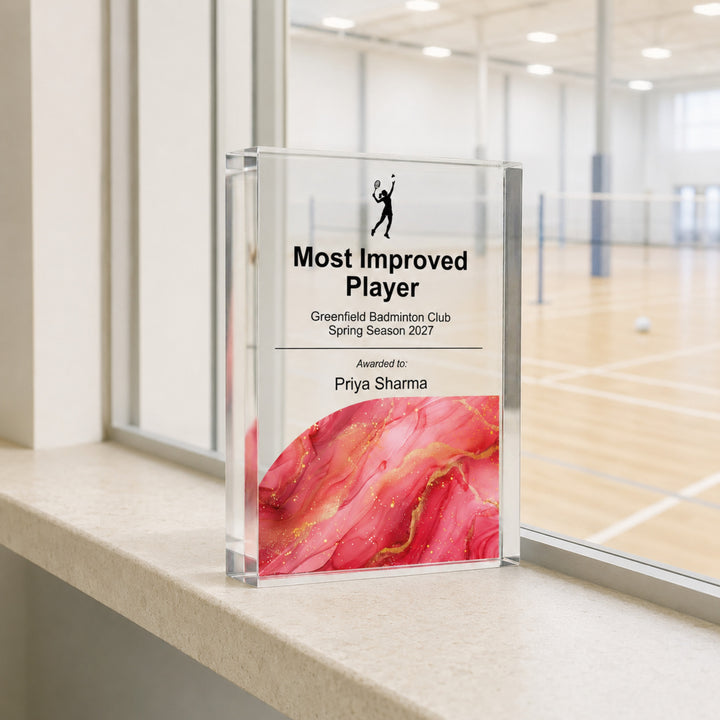 Personalised badminton trophy printed Most Improved Player with a red and pink base