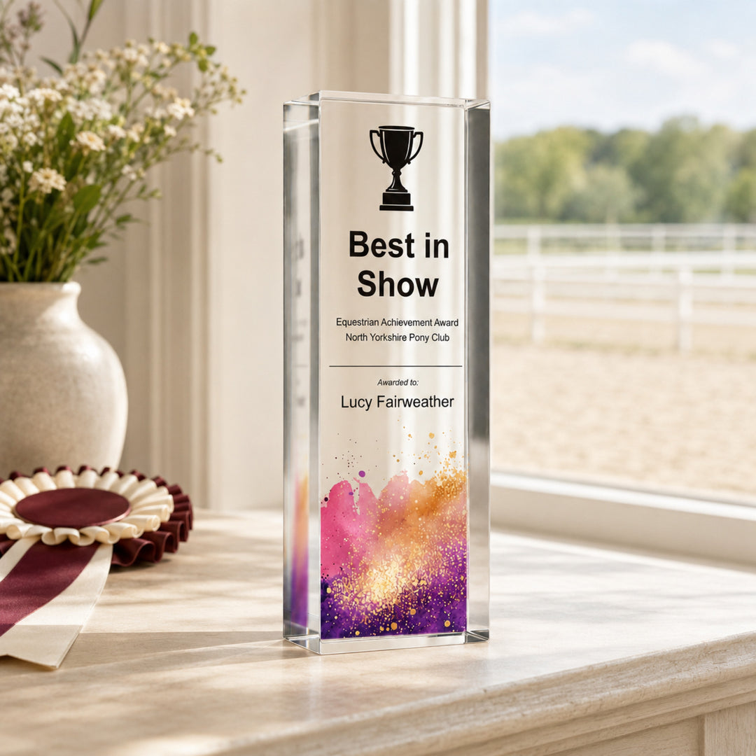 Slim upright personalised equestrian trophy printed Best in Show beside a rosette