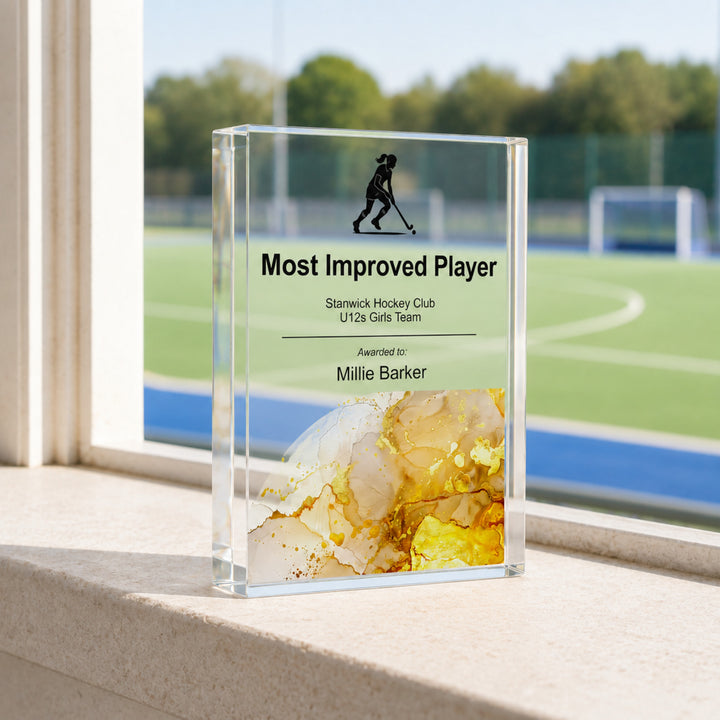 Personalised hockey trophy printed Most Improved Player with a player icon and amber base