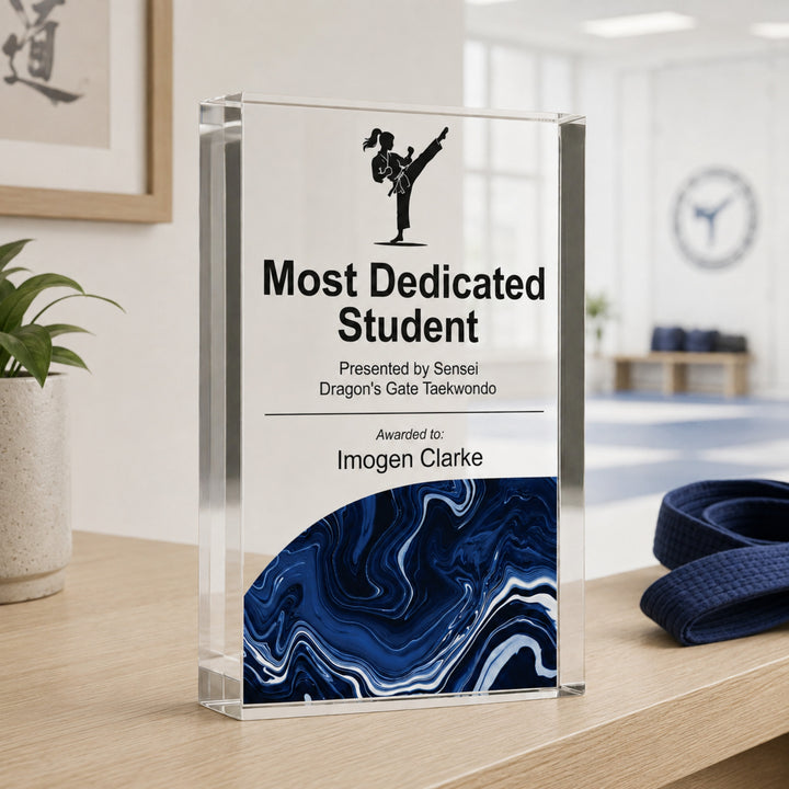 Personalised taekwondo trophy printed Most Dedicated Student with a kick icon and navy base