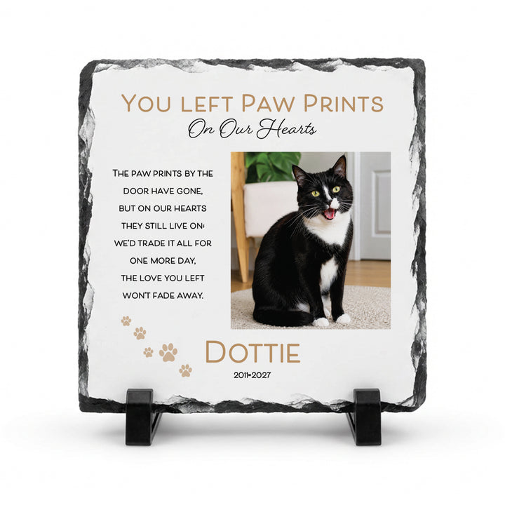 Paw print memorial stone in natural slate, 15x15cm small square, with a black and white cat named Dottie on a stand