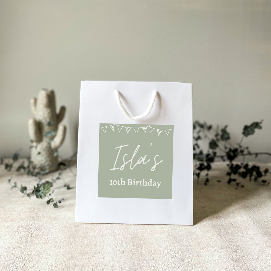 White personalised birthday gift bag with rope handles, featuring a green custom sticker