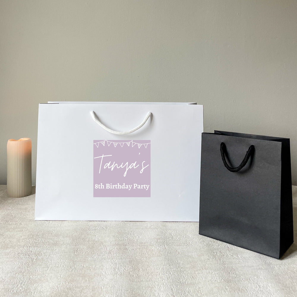 White & black personalised birthday gift bag with rope handles, featuring a green custom sticker