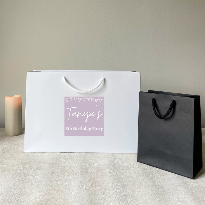 White & black personalised birthday gift bag with rope handles, featuring a green custom sticker