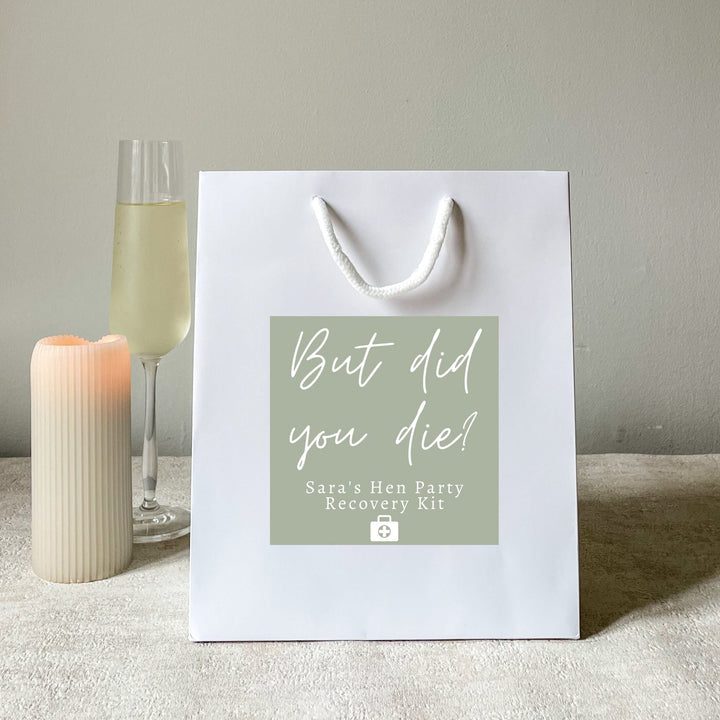 A white color hen party gift bags with the stickers
