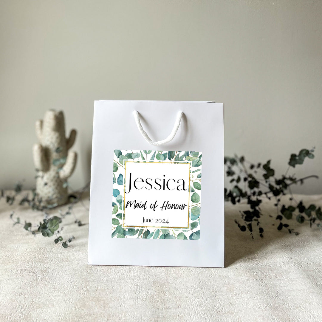 A white hen party gift bags with premium handles and the premium stickers name Jessica 