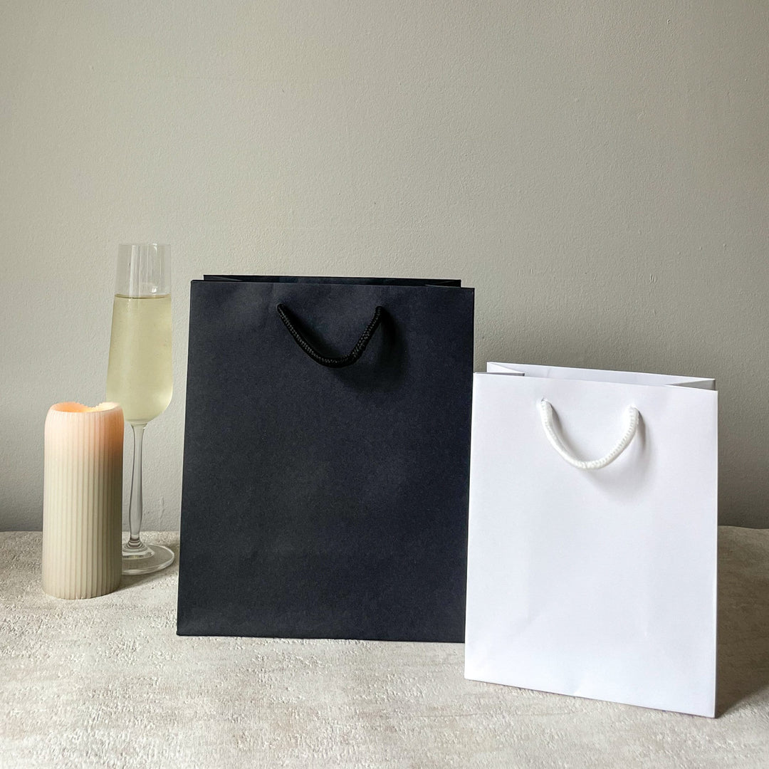 Luxury Personalised Bride Squad White Gift Bag and white sticker with gold foil writing and sticker. The Sticker writing says Bride Squad. Perfect for hen party favours and hen party gift bags for your bride tribe on your hen do and bridesmaid gifts.