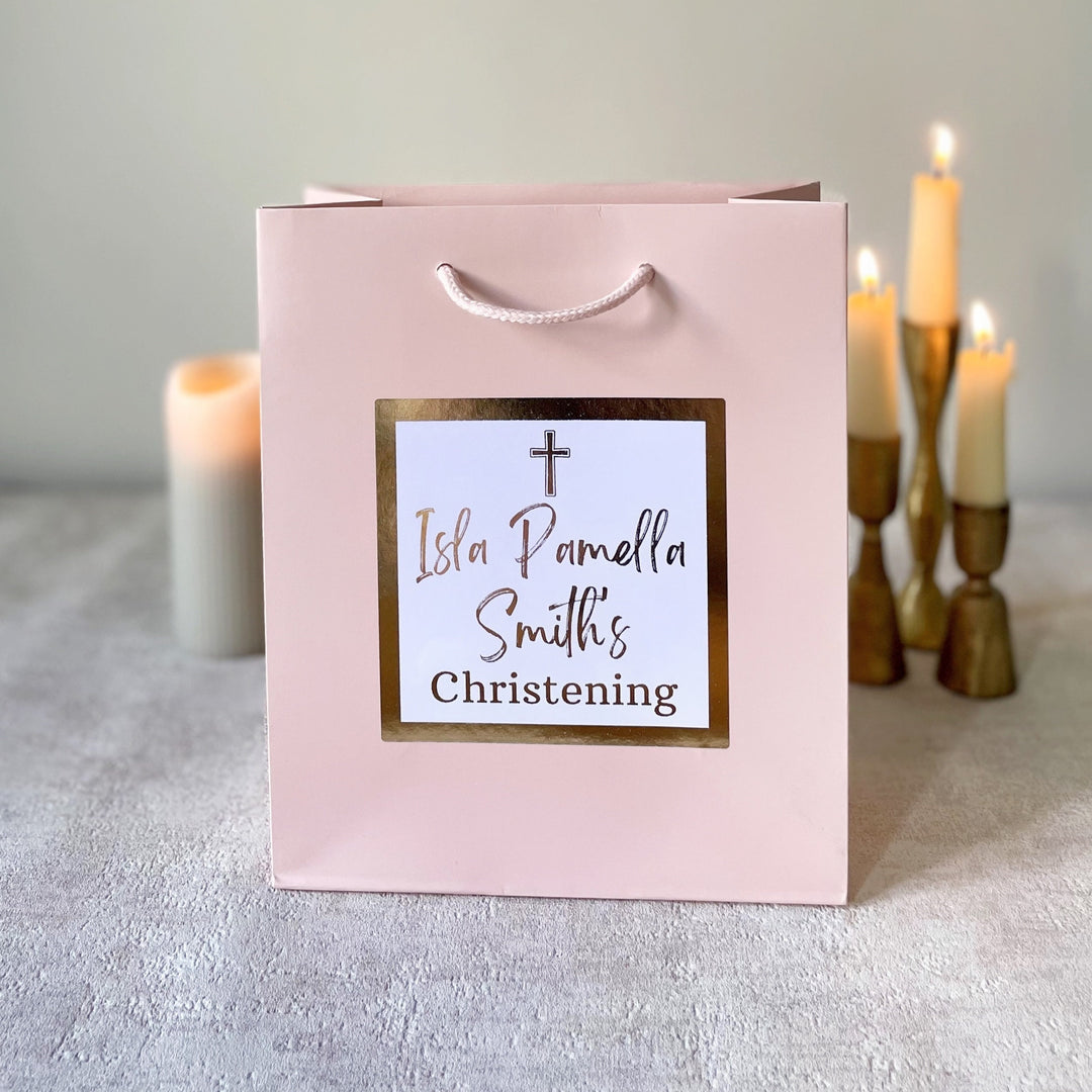 Pink colour christening gift bags.With text personalisation visible on the pink bag.