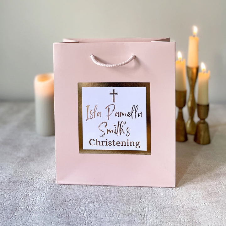 Pink colour christening gift bags.With text personalisation visible on the pink bag.