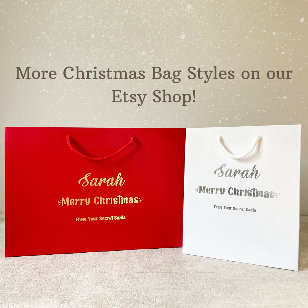 A personalised Christmas gift bag for children with the name 'Luke' printed on it, along with the message 'Merry Christmas' in festive lettering, placed on a table with a vase and flowers in the background.