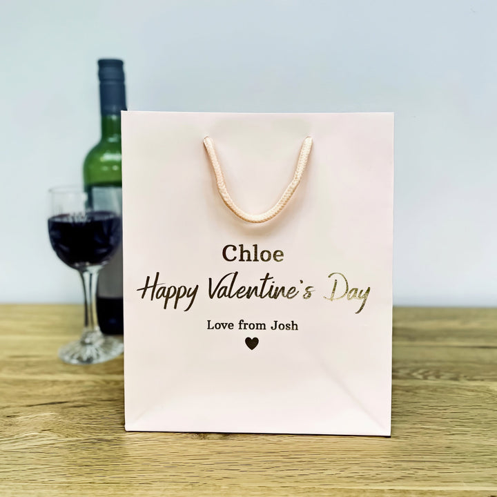 A kight pink valentine gift bags with "chole happy valentine's Day"